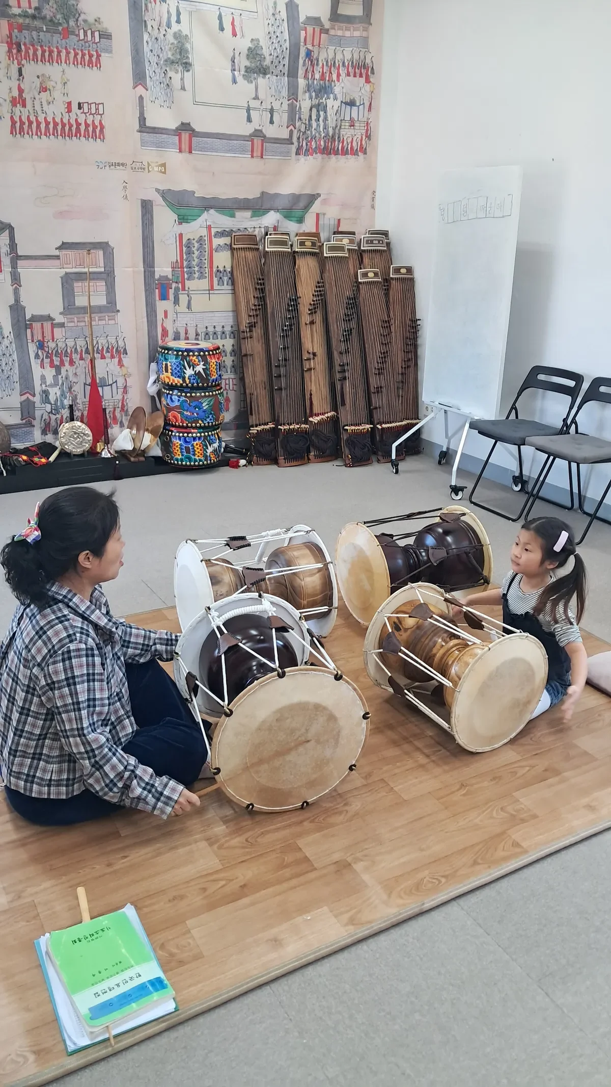 유치원아이에게 장구를 알려주고있는 송리결 선생님